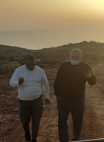 Inspecting the field with his companion, Mukhtar Ali Wehbeh.
